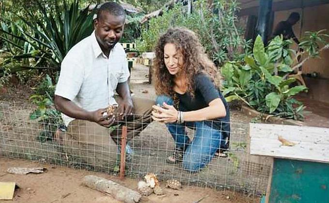 In the nursery one of the staff is showing some of the Sulcata offspring to Farah Vercouter